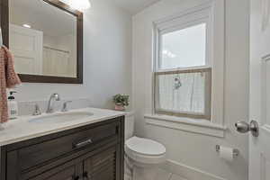 Bathroom featuring vanity, curtained shower, and tile patterned flooring
