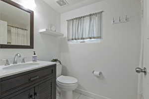Bathroom with vanity, a shower with shower curtain, and light tile patterned floors