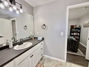 Ensuite bathroom featuring vanity and baseboards
