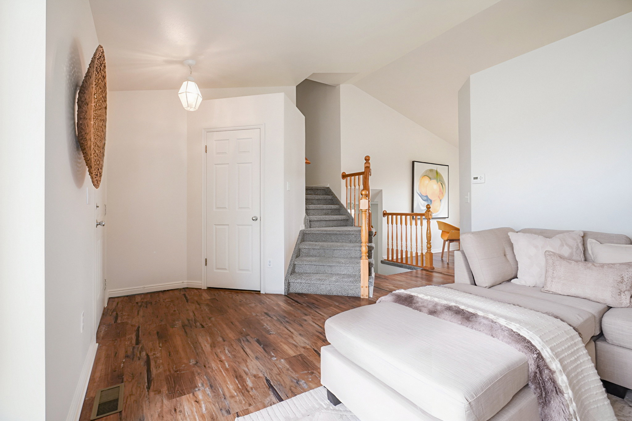 Living room featuring wood finished floors and vaulted ceiling
