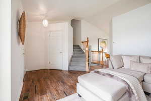 Living room featuring wood finished floors and vaulted ceiling