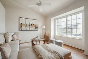 Bedroom with wood finished floors, lofted ceiling, and ceiling fan