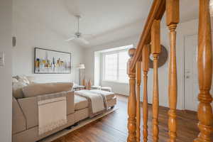 Bedroom featuring vaulted ceiling, wood finished floors, and ceiling fan