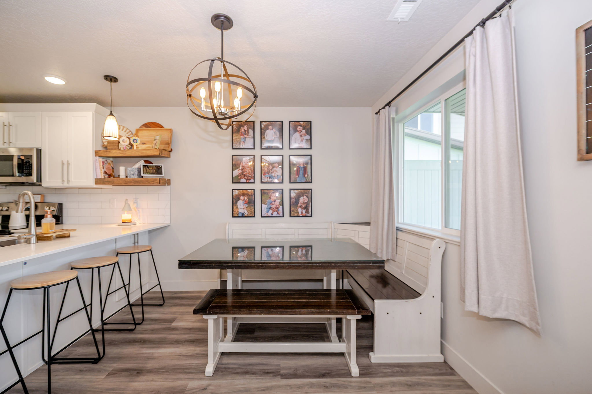 Dining space featuring dark wood-style flooring, hanging lights, and breakfast area