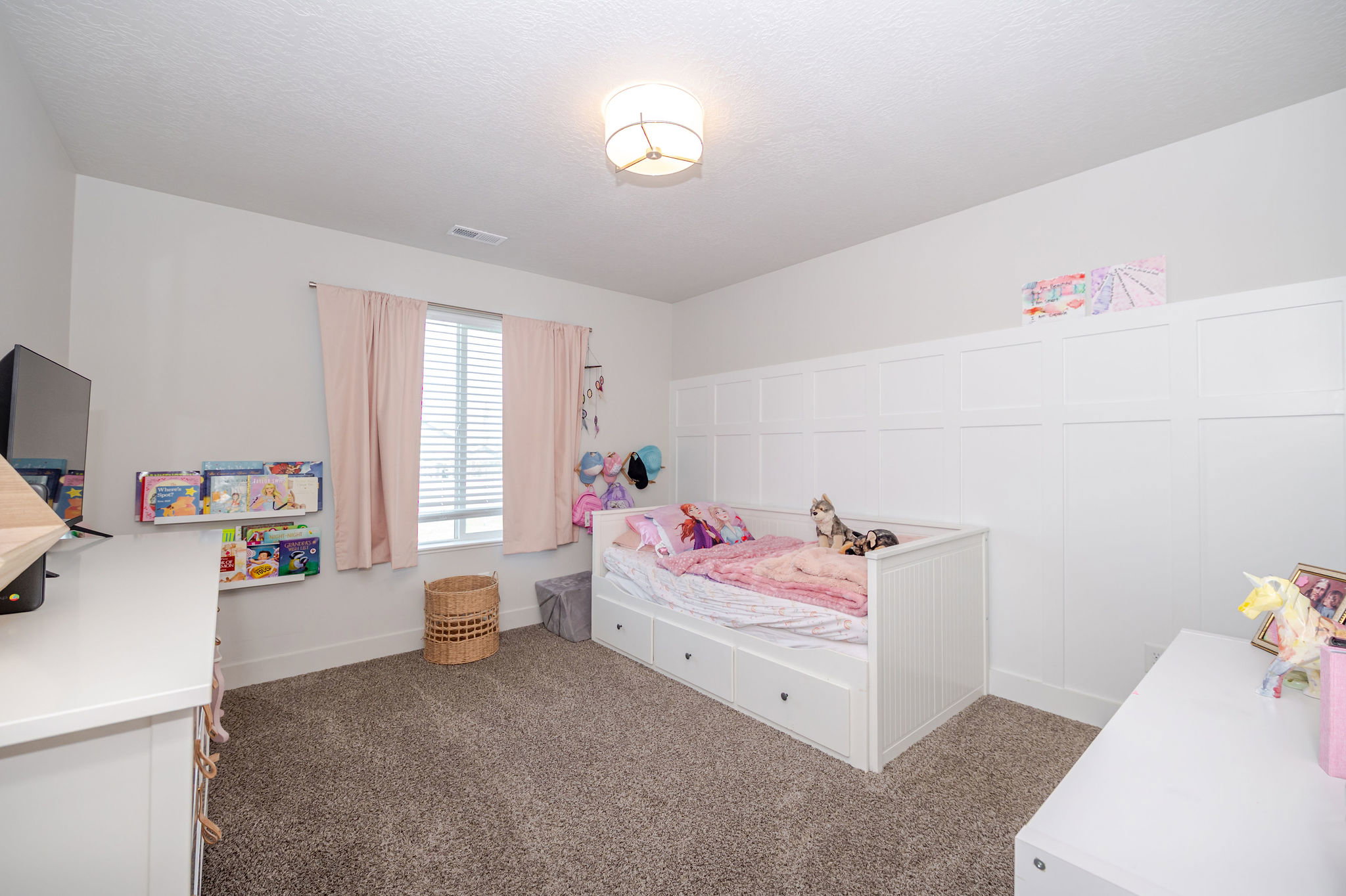 Bedroom with dark colored carpet and baseboards