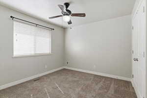 Spare room featuring carpet floors and ceiling fan