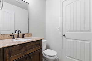 1/2 Bathroom with vanity and toilet