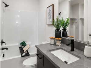 Full bath with vanity, light wood-style flooring, shower / washtub combination, and recessed lighting