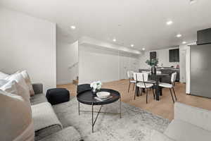 Living room featuring light wood-style flooring and recessed lighting