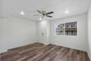 Spare room featuring a ceiling fan, dark wood-type flooring, and recessed lighting