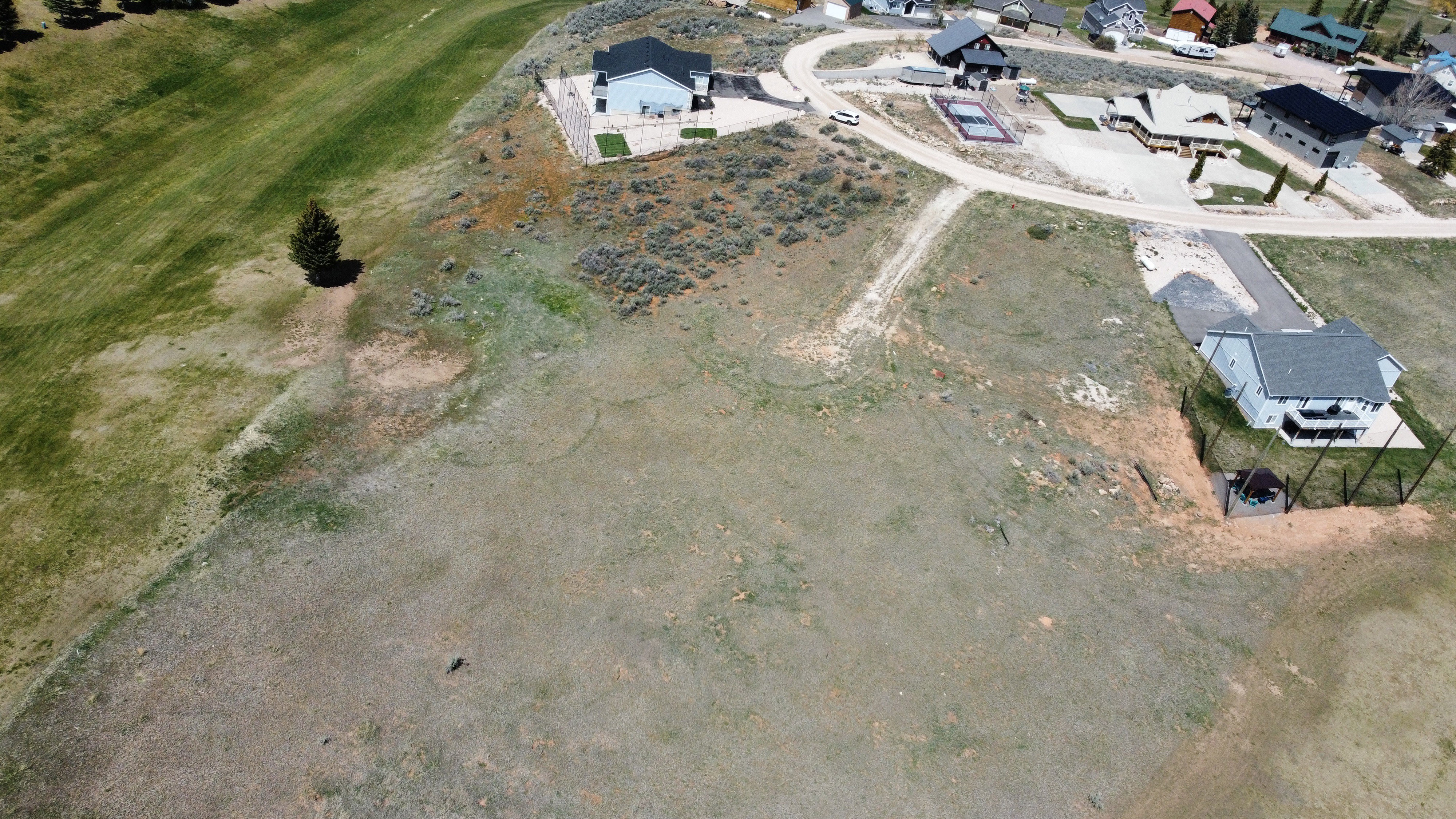 Aerial view of property's location with nearby suburban area