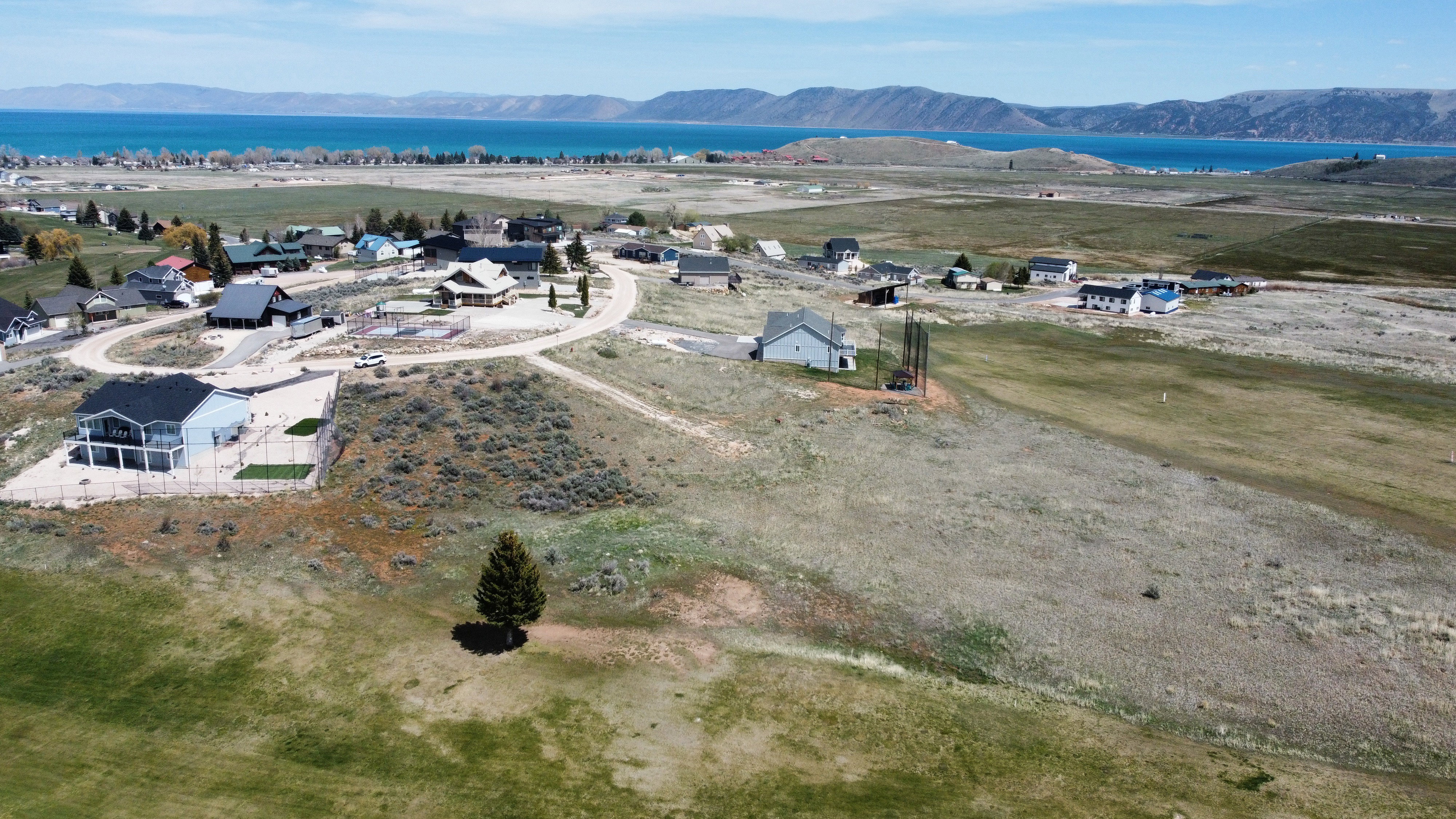 Aerial perspective of suburban area featuring a water and mountain view