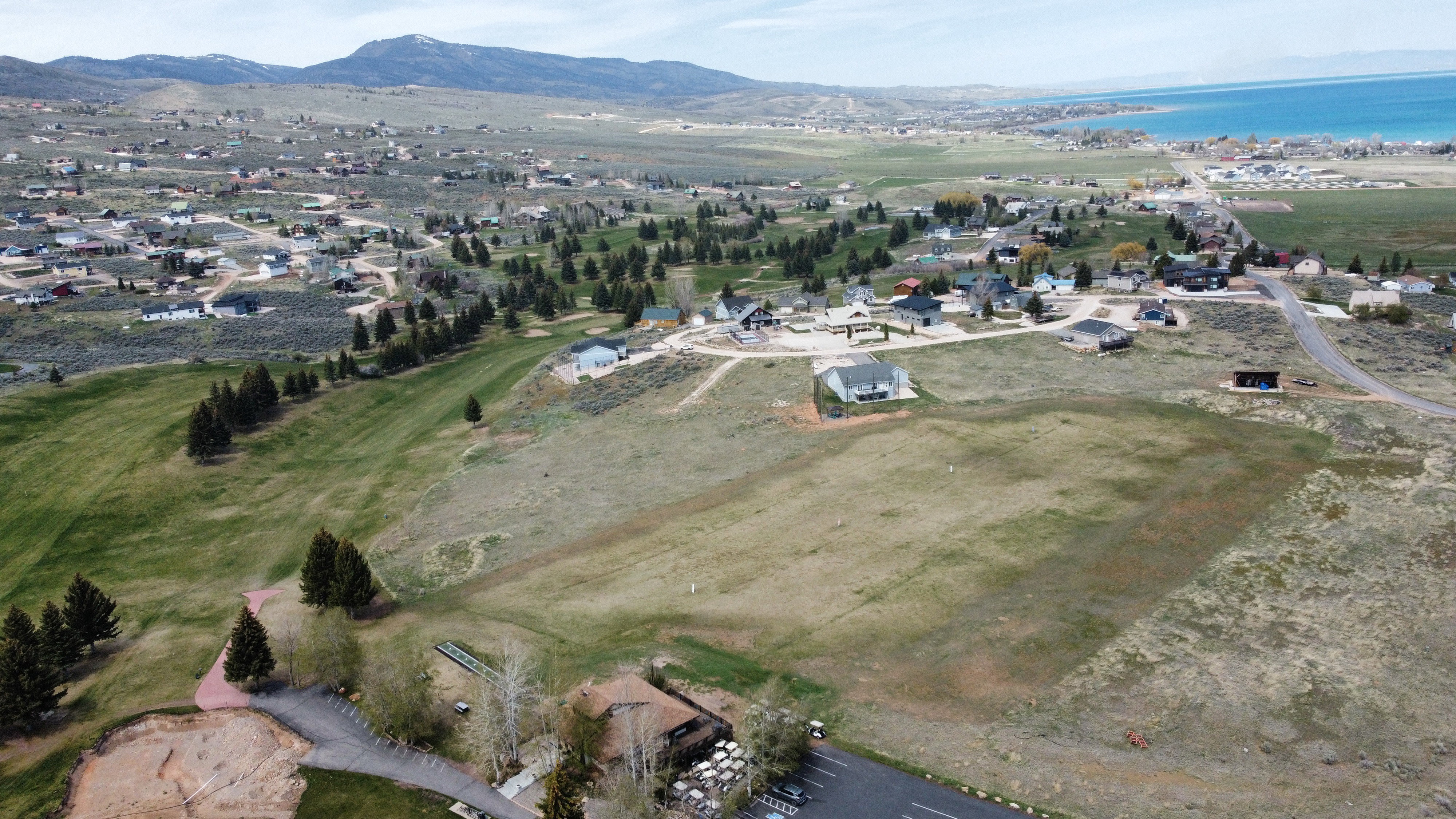Aerial view of property's location featuring a water and mountain view