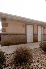 Garage entrance with stucco siding