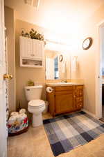 Full bath with vanity and light tile patterned floors
