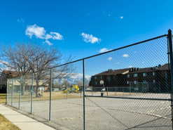 View of tennis court converted to off leash dog area