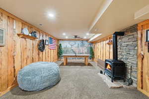 Playroom featuring wooden walls, recessed lighting, a gas stove, ceiling fan, and carpet