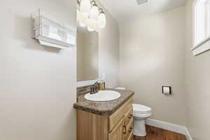 Bathroom featuring vanity and dark wood-style floors