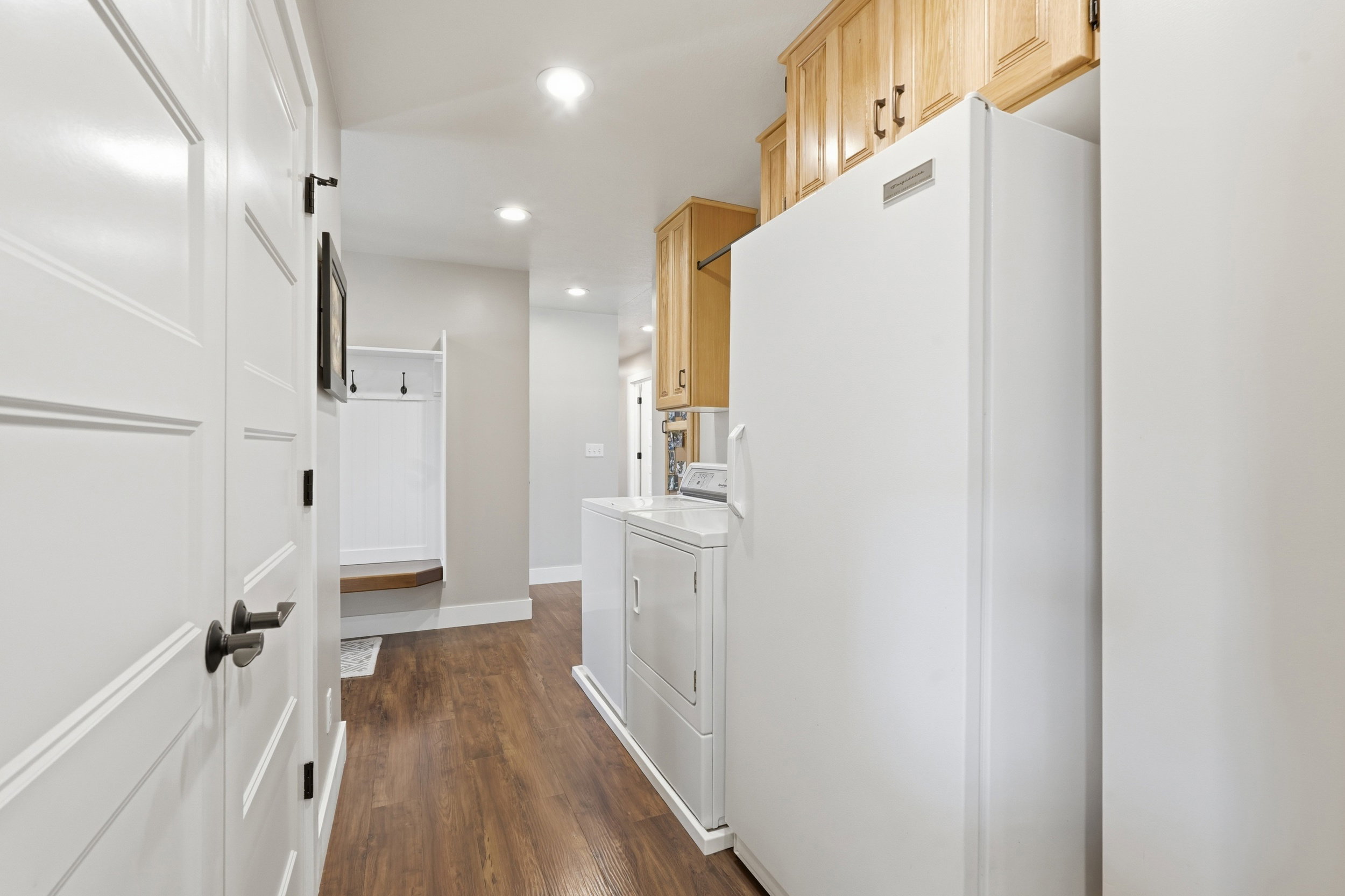Laundry area with recessed lighting, dark wood-style flooring