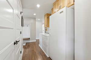 Laundry area with recessed lighting, dark wood-style flooring