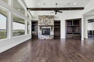 Unfurnished living room with beamed ceiling, dark wood finished floors, recessed lighting, a fireplace, and a ceiling fan