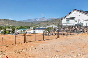 View of yard featuring a gate, a mountain view, and a residential view