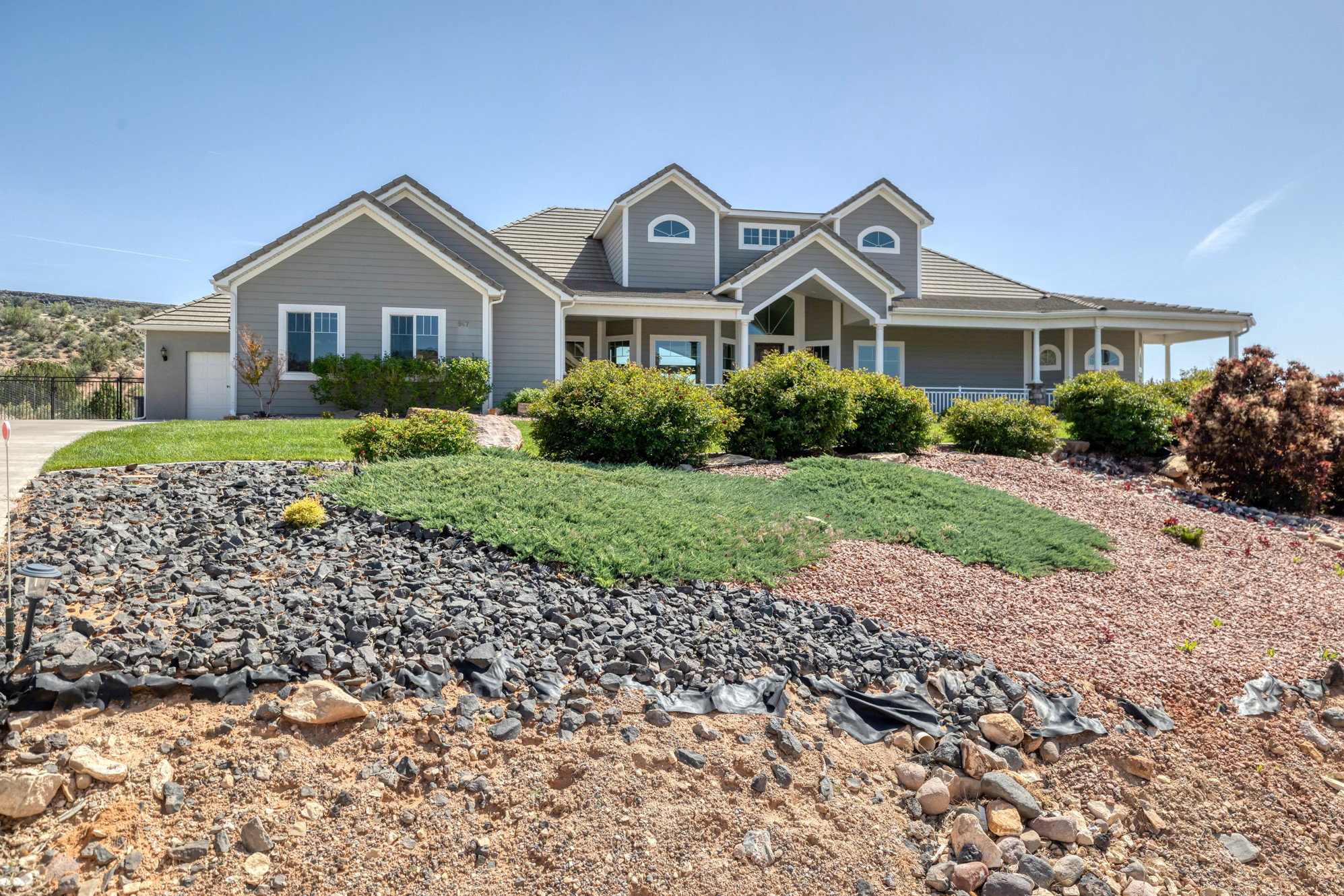 View of front of home with a porch and an attached garage