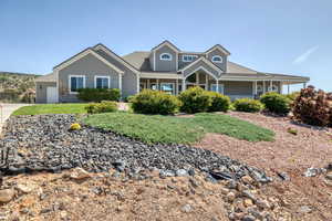 View of front of home with a porch and an attached garage