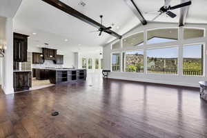 Unfurnished living room with ceiling fan, dark wood finished floors, recessed lighting, and lofted ceiling