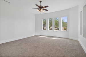 Unfurnished room with carpet and ceiling fan