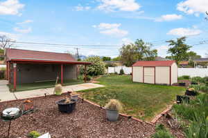 Fenced backyard with a storage unit