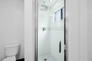 Walk-in shower with modern tile surround and updated fixtures for a clean, refreshed look.