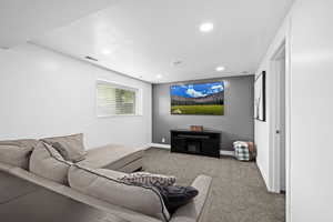 Cozy lower-level family room with soft lighting and a comfortable layout—perfect for movie nights, game days, or unwinding at the end of the day.