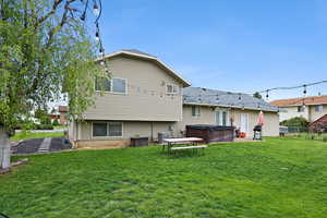 Expansive backyard with mature tree, an open lawn, and dreamy mountain views. Perfect for entertaining, relaxing, or enjoying Utah evenings under the lights.