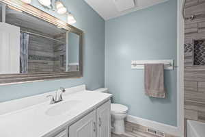 Stylish main bathroom with updated finishes, fresh tones, and a beautifully custom tiled shower surround.