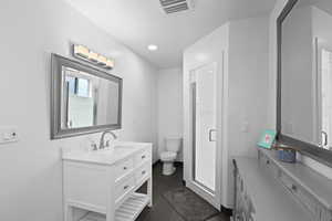 Updated primary bathroom with modern vanity, walk-in shower, and clean, bright finishes.