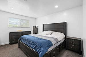 Spacious primary bedroom with soft natural light, neutral tones, and plenty of room to unwind.