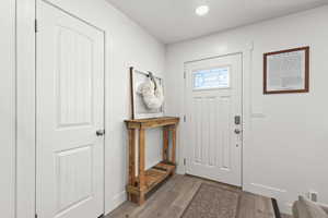 Bright, clean entry with updated flooring, neutral tones, and a welcoming front door with natural light.