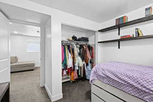 Cozy bedroom with open closet storage and easy access to additional living space—comfortable, functional, and well-connected.