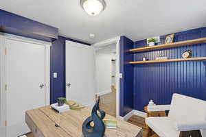 Home office featuring wood tiled floors and a textured ceiling