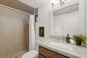 Bathroom featuring vanity and a stall shower