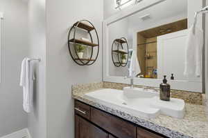 Bathroom featuring vanity and baseboards
