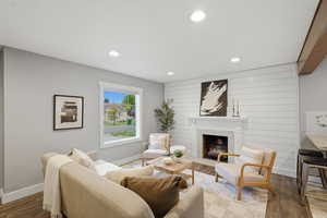 Living area featuring a large fireplace, wood finished floors, and recessed lighting