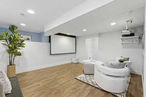 Cinema featuring wainscoting, recessed lighting, and light wood-type flooring