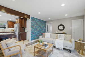 Living area with wallpapered walls, recessed lighting, and light wood finished floors