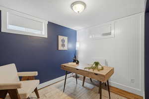 Office area featuring wood finished floors and a textured ceiling
