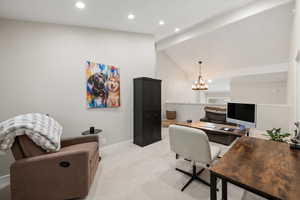 Office space featuring hanging lights and light carpet