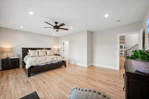 Bedroom featuring light wood-style flooring, ceiling fan, and recessed lighting