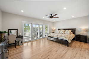 Bedroom with access to exterior, light wood-type flooring, ceiling fan, and recessed lighting