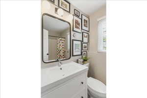 Full bathroom with vanity and curtained shower